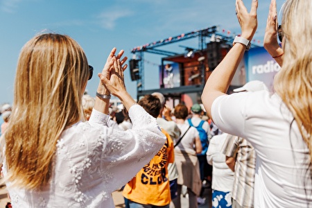 People applaud for stage on the seawall